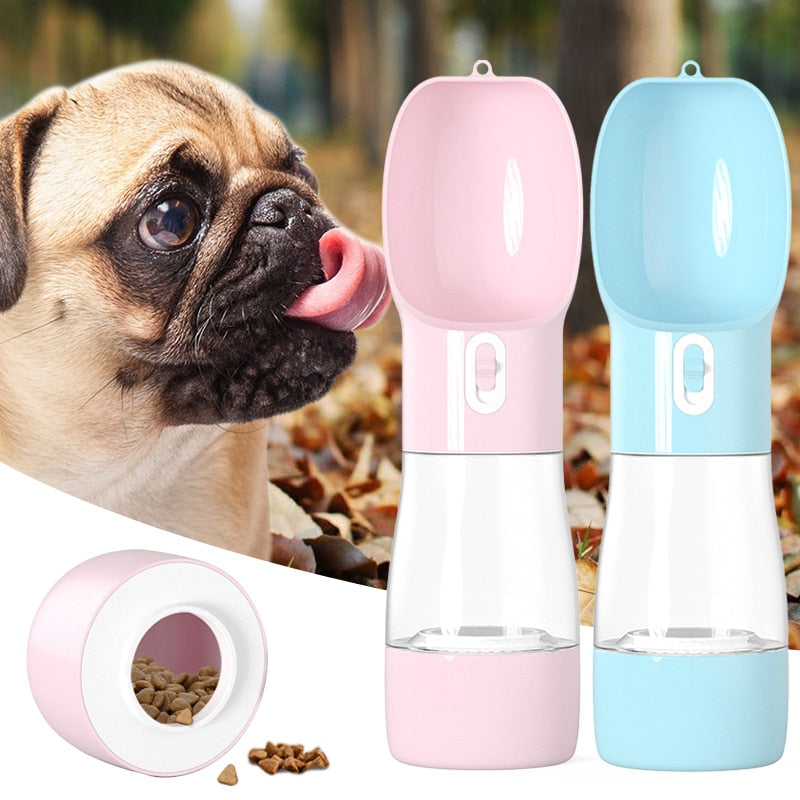Dog beside pink and blue portable pet water and food dispensers