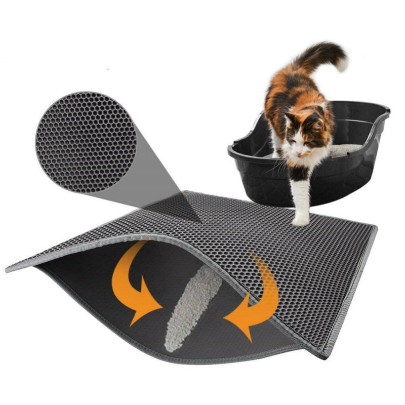 Cat stepping from litter box onto a gray double-layer honeycomb litter mat