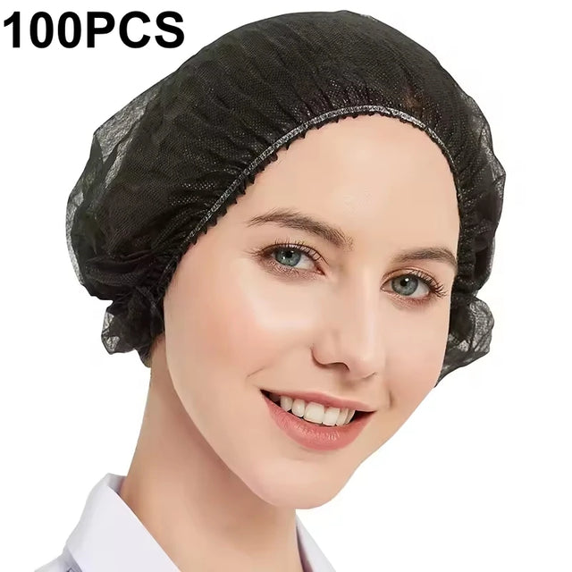 Black disposable bouffant cap worn on a model with 100-piece pack quantity shown.