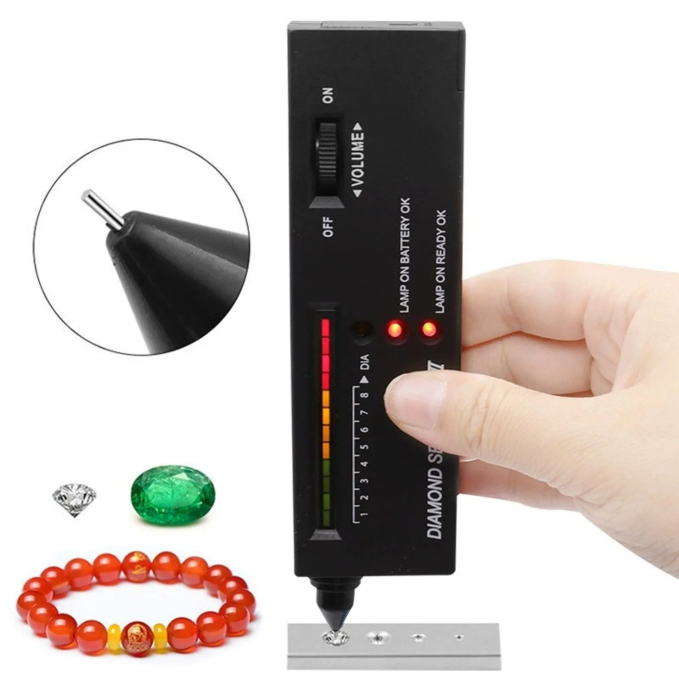 Handheld diamond tester pen contacting a test plate beside loose stones