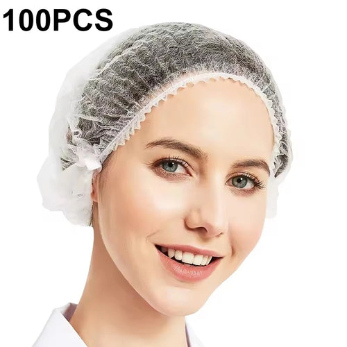 White disposable bouffant cap worn on a model with 100-piece pack quantity shown.