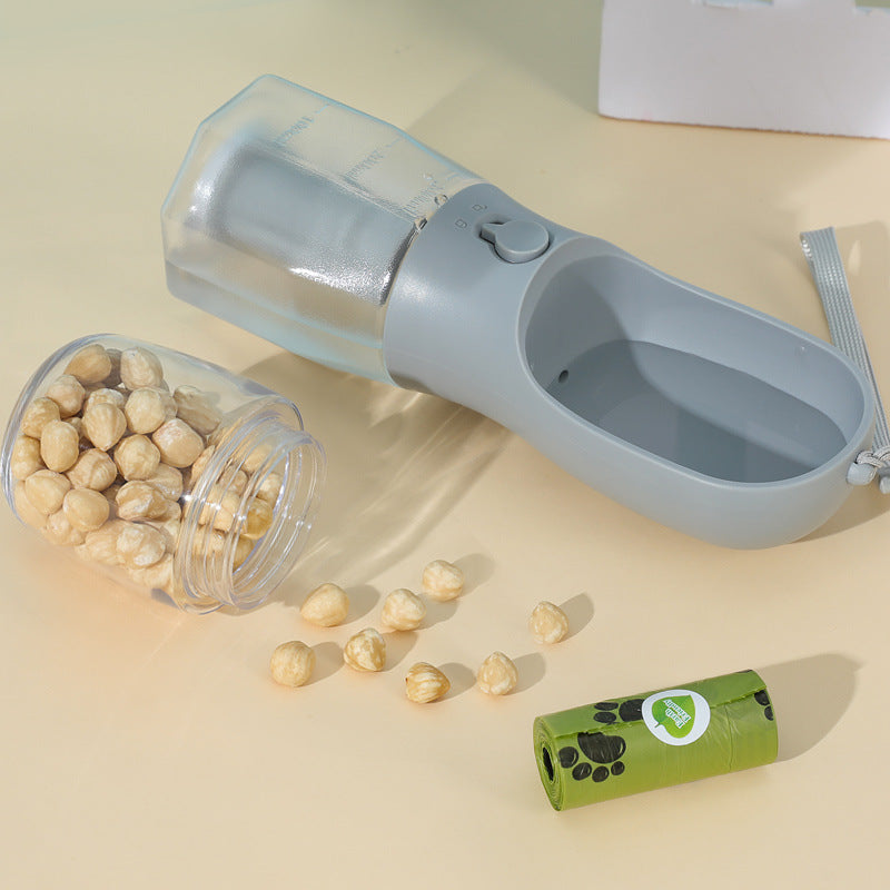 Gray 3-in-1 pet bottle with food container and trough; bag roll shown to illustrate base storage